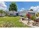 Charming single-story home features lush landscaping and a bright blue front door at 2516 Dixon Ter, Port Charlotte, FL 33981