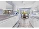 Bright kitchen with white appliances, tile floors, and breakfast nook with views of the yard at 2516 Dixon Ter, Port Charlotte, FL 33981