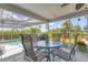Covered lanai offers views of the pool, canal and tropical landscaping creating a relaxing outdoor space at 2516 Dixon Ter, Port Charlotte, FL 33981