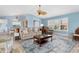 Open-concept living room with blue walls, tile flooring, and comfortable seating arrangements at 2516 Dixon Ter, Port Charlotte, FL 33981