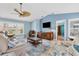 Comfortable living room features a ceiling fan and a large window providing ample natural light at 2516 Dixon Ter, Port Charlotte, FL 33981