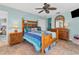 Main bedroom features colorful bed linens, wooden furniture, and ceiling fan at 2516 Dixon Ter, Port Charlotte, FL 33981