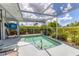 Private pool enclosed in a screen provides a refreshing escape surrounded by lush landscaping and sun at 2516 Dixon Ter, Port Charlotte, FL 33981