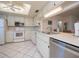 Bright kitchen with white cabinetry and stainless steel appliances at 139 Jose Gaspar Dr # 139, Englewood, FL 34223