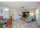 Living room with tiled floors, comfy seating, and access to patio at 139 Jose Gaspar Dr # 139, Englewood, FL 34223
