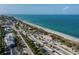 Aerial view of coastline with beach, parking, and oceanfront buildings at 139 Jose Gaspar Dr # 139, Englewood, FL 34223