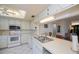 White kitchen with stainless steel appliances and view into dining area at 139 Jose Gaspar Dr # 139, Englewood, FL 34223