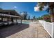 Community pool area with covered patio, tables, chairs, and lounge chairs at 139 Jose Gaspar Dr # 139, Englewood, FL 34223