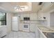 Bright kitchen features white cabinetry, tile floors, and stainless steel appliances at 139 Jose Gaspar Dr # 139, Englewood, FL 34223
