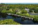 Aerial view of waterfront property with private docks and lush landscaping at 139 Jose Gaspar Dr # 139, Englewood, FL 34223