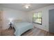 Cozy bedroom with laminate wood flooring and a window with blinds at 139 Jose Gaspar Dr # 139, Englewood, FL 34223