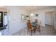 Dining area with glass top table and four chairs, adjacent to kitchen at 139 Jose Gaspar Dr # 139, Englewood, FL 34223