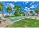 Community shuffleboard court with benches and palm trees under a sunny sky at 6551 Hamlet Dr # 22A, Englewood, FL 34224