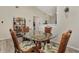 Charming dining area featuring a glass-top table and wicker chairs at 6551 Hamlet Dr # 22A, Englewood, FL 34224
