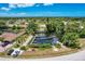 Aerial view showcasing waterfront property with private boat docks and a tranquil canal at 6551 Hamlet Dr # 22A, Englewood, FL 34224