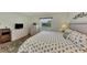 King-size bed, dresser, TV, and view of backyard from bedroom window at 6551 Hamlet Dr # 22A, Englewood, FL 34224