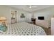 Spacious bedroom with a king-size bed, dresser, and en-suite bathroom at 6551 Hamlet Dr # 22A, Englewood, FL 34224
