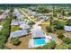 Aerial view of community with pool, shuffleboard, and numerous homes at 6551 Hamlet Dr # 22A, Englewood, FL 34224