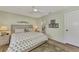 King-size bed, en-suite bathroom, and ceiling fan in bright bedroom at 6551 Hamlet Dr # 22A, Englewood, FL 34224