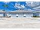 Three-car garage with gray doors and ample parking space at 6551 Hamlet Dr # 22A, Englewood, FL 34224