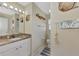 Bathroom with granite vanity, large mirror, and shower at 6551 Hamlet Dr # 22A, Englewood, FL 34224