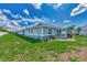 Backyard view of home with grassy lawn and screened patio at 6551 Hamlet Dr # 22A, Englewood, FL 34224