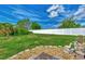 Landscaped backyard with a stone pathway and a goose statue at 6551 Hamlet Dr # 22A, Englewood, FL 34224