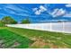 Long backyard with a white vinyl fence and grassy lawn at 6551 Hamlet Dr # 22A, Englewood, FL 34224