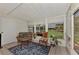 Relaxing screened porch with wicker furniture and backyard view at 6551 Hamlet Dr # 22A, Englewood, FL 34224
