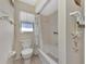 Bathroom with tub, shower, and window for natural light at 6551 Hamlet Dr # 22A, Englewood, FL 34224