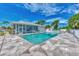 Community pool with patio furniture and screened enclosure at 6551 Hamlet Dr # 22A, Englewood, FL 34224