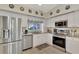 Modern kitchen featuring stainless steel appliances and granite countertops at 6551 Hamlet Dr # 22A, Englewood, FL 34224