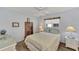 Bedroom with a queen-size bed, dresser, and window at 6551 Hamlet Dr # 22A, Englewood, FL 34224
