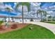 Neat row of attached garages with landscaping and a driveway at 6551 Hamlet Dr # 22A, Englewood, FL 34224