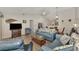 Bright living room with comfy seating, large TV, and view to dining area at 6551 Hamlet Dr # 22A, Englewood, FL 34224