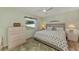 King-size bed, dresser, ceiling fan, and backyard view from window at 6551 Hamlet Dr # 22A, Englewood, FL 34224