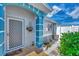 Front entry of a condo with a white door and blue accents at 6551 Hamlet Dr # 22A, Englewood, FL 34224