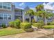 Gray building exterior with lush landscaping and walkway at 4410 Warren Ave # 204, Port Charlotte, FL 33953