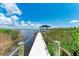 White dock with wooden posts and rope railings extends over a calm waterway at 16147 Lankford Ct, Port Charlotte, FL 33981