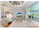 Bright living room featuring gray sofas, a large TV, and access to a lanai with pool views at 16147 Lankford Ct, Port Charlotte, FL 33981