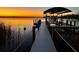 Night view of a private dock with lights and a boat at 16147 Lankford Ct, Port Charlotte, FL 33981