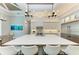 Modern kitchen featuring a large white island, white shaker cabinets, and stainless steel appliances at 16147 Lankford Ct, Port Charlotte, FL 33981