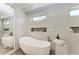 Bathroom with a freestanding bathtub and modern tile at 16147 Lankford Ct, Port Charlotte, FL 33981
