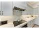 Clean kitchen design with white cabinets, marble countertops, and a built-in cooktop at 16147 Lankford Ct, Port Charlotte, FL 33981