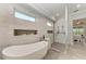 Luxurious bathroom featuring a freestanding soaking tub and a walk-in shower at 16147 Lankford Ct, Port Charlotte, FL 33981