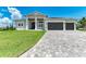 Two-story home with a three-car garage and landscaped lawn at 16147 Lankford Ct, Port Charlotte, FL 33981