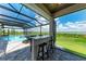 Covered lanai with pool, spa, and wet bar overlooking a tranquil waterway at 16147 Lankford Ct, Port Charlotte, FL 33981