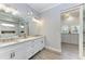 Elegant bathroom with double vanity, large mirror, and access to walk-in closet at 16147 Lankford Ct, Port Charlotte, FL 33981