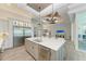 Modern kitchen with white cabinets, large island, stainless steel appliances, and wood-look floors at 16147 Lankford Ct, Port Charlotte, FL 33981