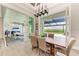 Open dining room with a large wooden table and sliding glass doors leading to the patio at 16147 Lankford Ct, Port Charlotte, FL 33981